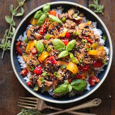 a bowl filled with vegetables and nuts on top of a table