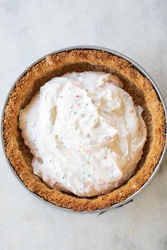 a pie topped with whipped cream and sprinkles