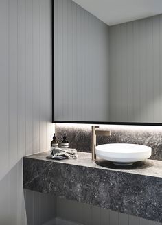 a bathroom sink sitting under a large mirror