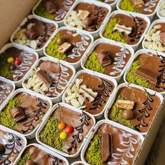 a box filled with lots of different types of desserts on top of each other