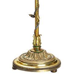 an ornate brass clock with a cross on it's side and birds perched on the top