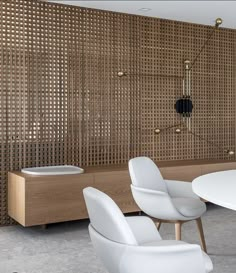 a white table and chairs in front of a wall with wooden slats on it