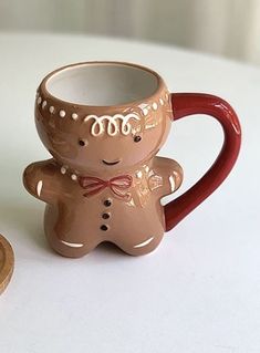 a ceramic mug with a ginger design on it and a wooden spoon next to it