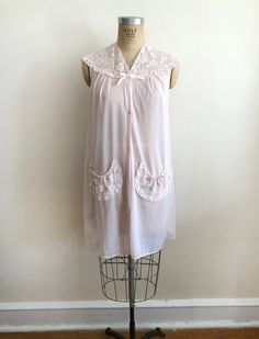 "Pale pink nightgown with lace yoke, from the 1970s. The bust measures 20.5\" (52 cm) flat across and the waist measures 23\" (58.5 cm) flat across. The night gown is 37.5\" (95 cm) in total length. 100% nylon. Original size is a small." Pink Sleeveless Chemise For Wedding Night, Sleeveless Pink Chemise For Wedding Night, Vintage Sleepwear With Lace Trim, Pink Lace Trim Dress For Loungewear, Pink Lace Trim Nightgown For Loungewear, Pink Lace Nightgown For Loungewear, Coquette Lace Trim Bedtime Dress, Vintage Pink Sleepwear, Pink Lace Trim Dresses For Bedtime