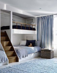 a bedroom with bunk beds and blue rugs