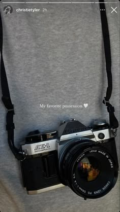 a camera attached to the back of a person's shirt with words written on it