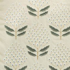 a white and green floral pattern on fabric