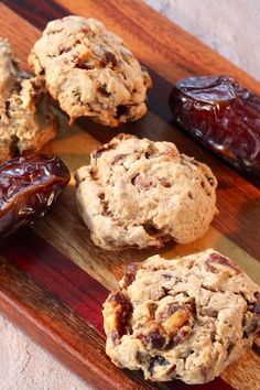 cookies and jelly on a cutting board with some dried fruit in the background to be eaten