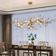 a dining room table with chairs and a chandelier hanging from it's ceiling