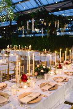 the tables are set with candles and place settings