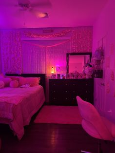 a bed room with a neatly made bed and purple lighting