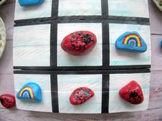 some rocks are painted with different colors and shapes