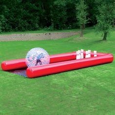 an inflatable ball sitting on top of a lawn