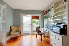 a living room filled with furniture and lots of bookshelves on top of shelves