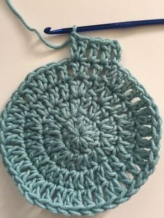 a crochet pot holder with yarn in the shape of a circle