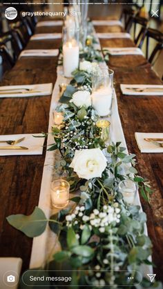 a long table with candles and flowers on it