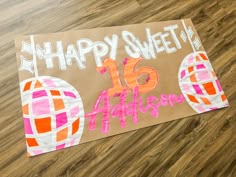 a sign that says happy sweet 16 affision on it's cardboard board