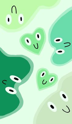 some green and white shapes with black dots on them in the shape of heart shaped eyes