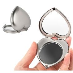 a person holding a compact mirror in their hand