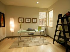 a living room filled with furniture next to a large window and a ladder in front of it