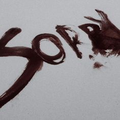 the word error written in black ink on a white paper with some brown paint splatters