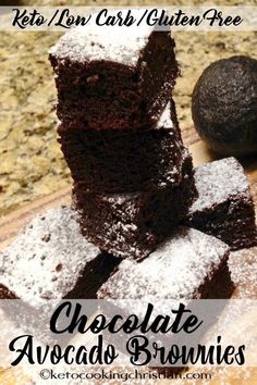 chocolate avocado brownies stacked on top of each other with powdered sugar