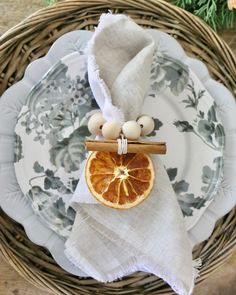 a grapefruit slice on a plate next to a napkin holder and some eggs