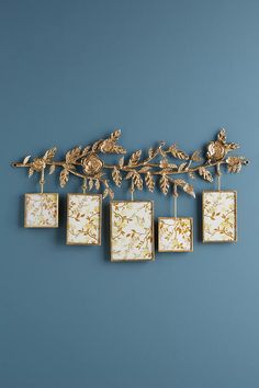 an ornately decorated wall hanging with four square frames