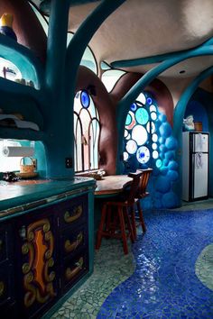 a kitchen with blue walls and stained glass windows