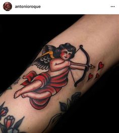 an angel with bow and arrow tattoo on the left arm is shown in this photo