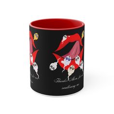 a black and red coffee mug with some cartoon characters on it