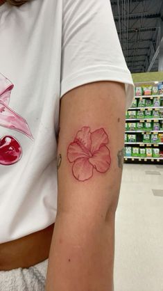 a woman with a flower tattoo on her arm