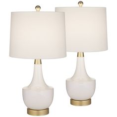 two white table lamps with gold accents on them