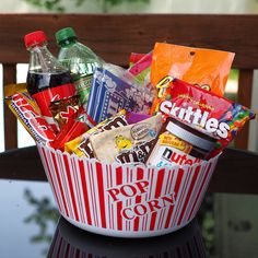 a bowl filled with snacks and drinks on top of a table