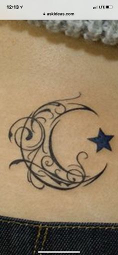 a crescent and star tattoo on the side of a woman's lower back stomach