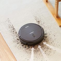 a robot vacuum cleaning the floor with dirt on it