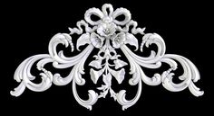 an ornate white brooch on a black background