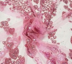 pink sequins and bows on white fabric