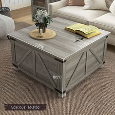 a coffee table with a book on it and a vase full of flowers in the middle