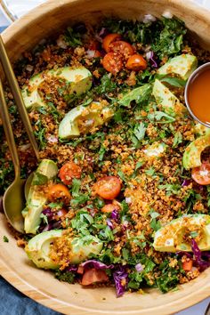 a wooden bowl filled with salad and dressing