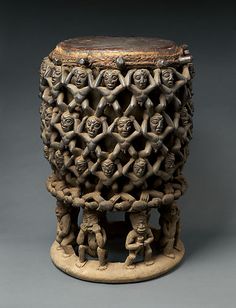 an old ceramic vase with many faces on it