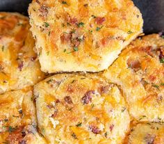 some biscuits are stacked on top of each other in a pile and topped with fresh herbs