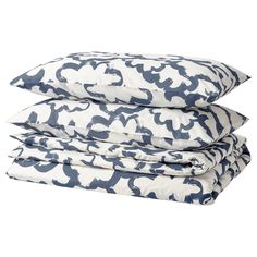 three pillows stacked on top of each other with blue and white designs in the middle