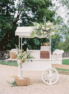 a white cart with flowers and candles on it