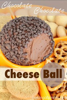 cheese ball with chocolate frosting on top and pretzels in the middle, surrounded by other snacks