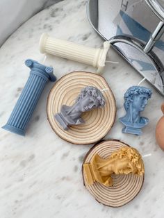 some toys are sitting on top of a marble table next to an egg and other items