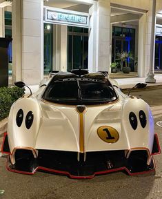 a white race car parked in front of a building