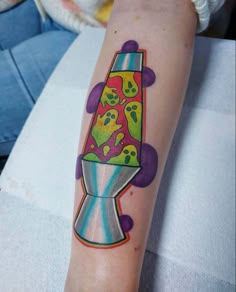 a colorful tattoo on the arm of a person with an object in it's center