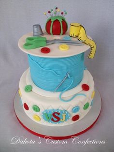 a birthday cake that is made to look like it has a hat and thread on top