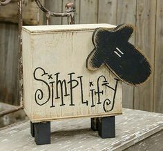 a wooden sign with a black hat on it that says simpliff and the word